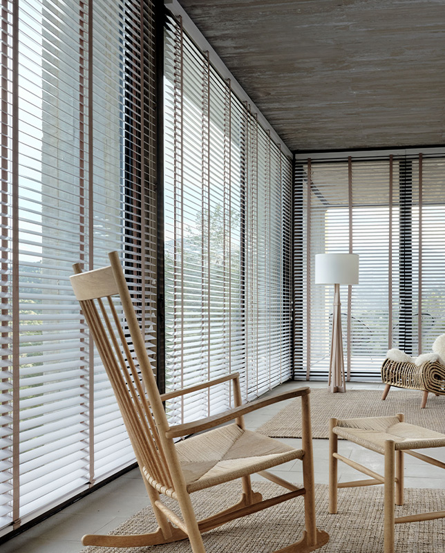 Decorquip white Real Wood Venetian blinds covering floor-to-ceiling windows in a neutral living room