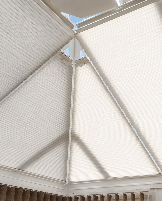 Decorquip white pleated conservatory blinds fitted to shaped roof glazing