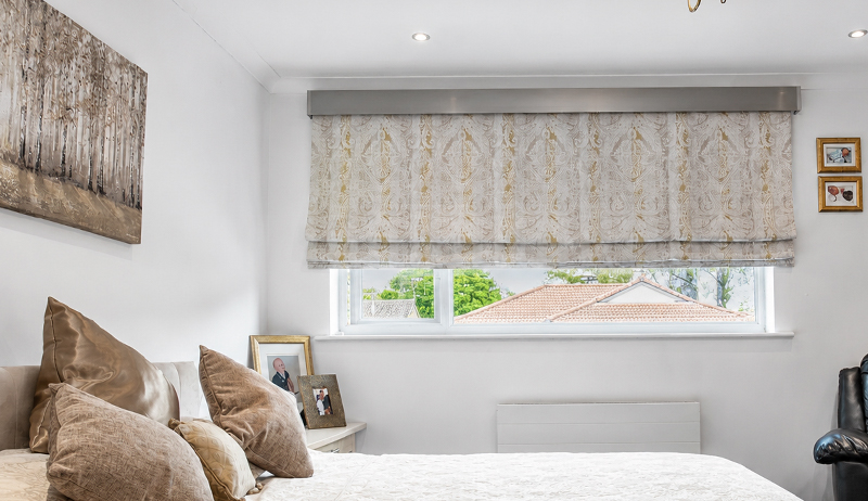 Decorquip terracotta roller blinds with champagne Capital Fascia lowered across three windows in a modern living room
